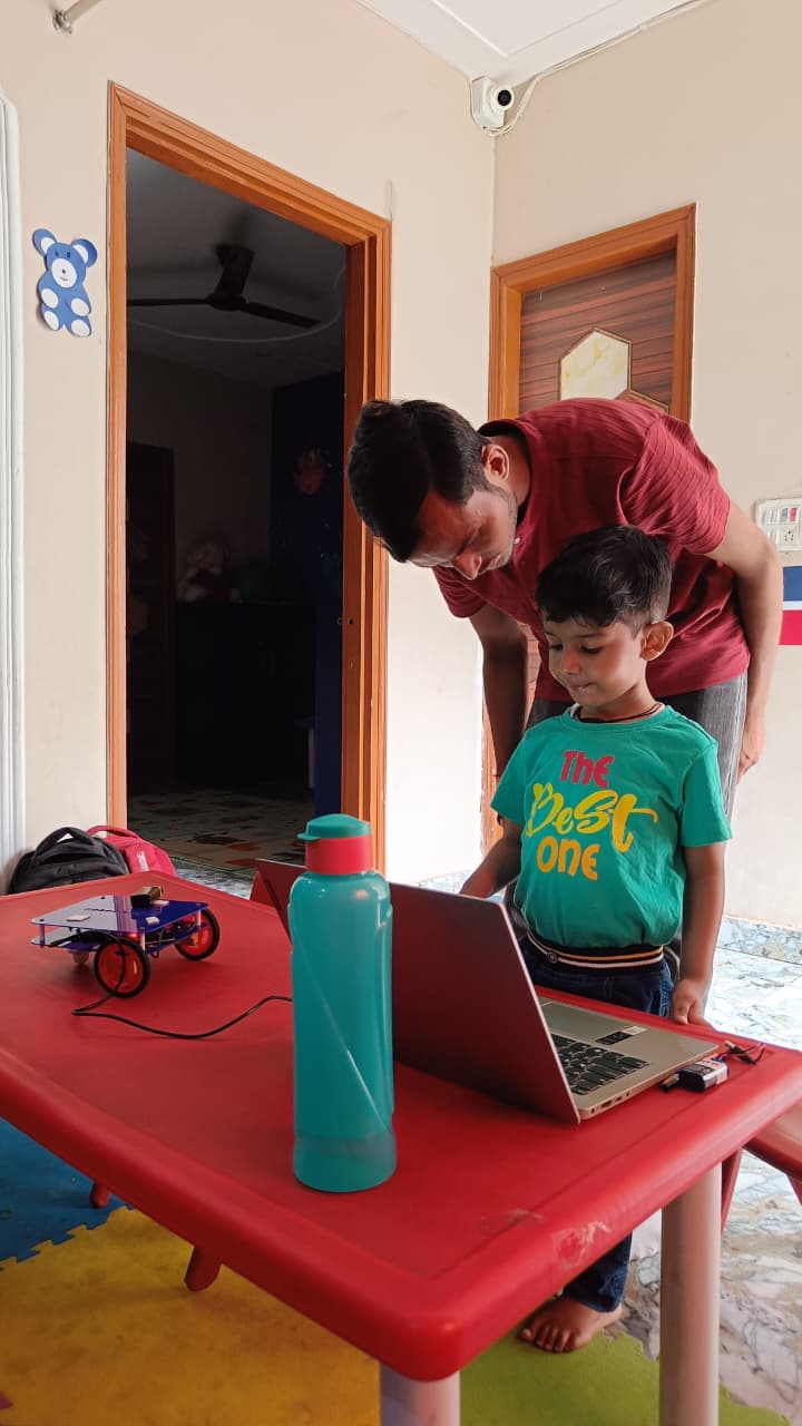 Student holding programmable car